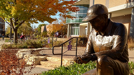 Statue of man holding soil