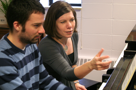 Professor working with student playing piano