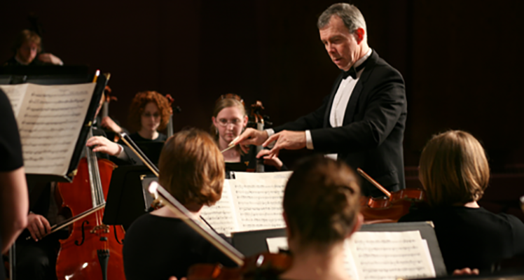 Man directing orchestra