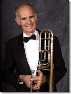 Dr. James Wheat poses with a trombone.