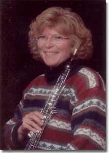 Professor Kristi Krause holds an oboe.