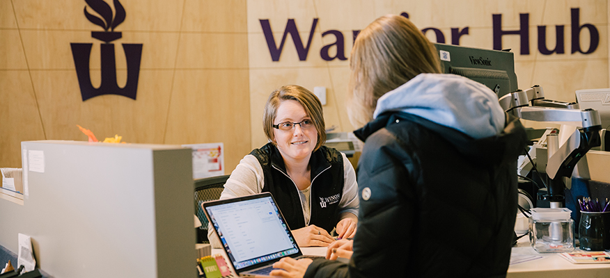 A WSU student gets help from staff at the Warrior Hub.