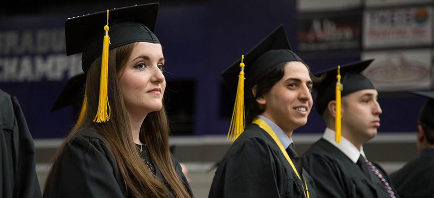 male and female students in graduation cap and gowns during the WSU commencement ceremony