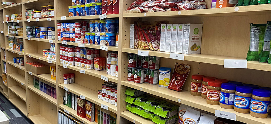 Canned and boxed goods on shelves in the Warrior Cupboard.